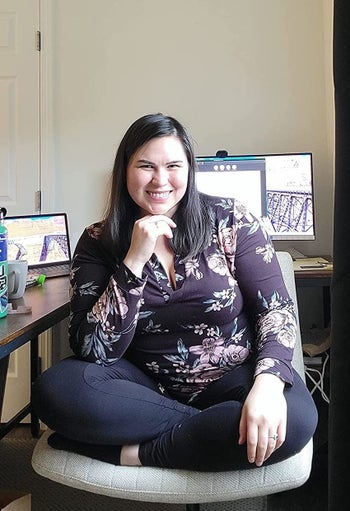 Reviewer sits cross-legged in her office chair