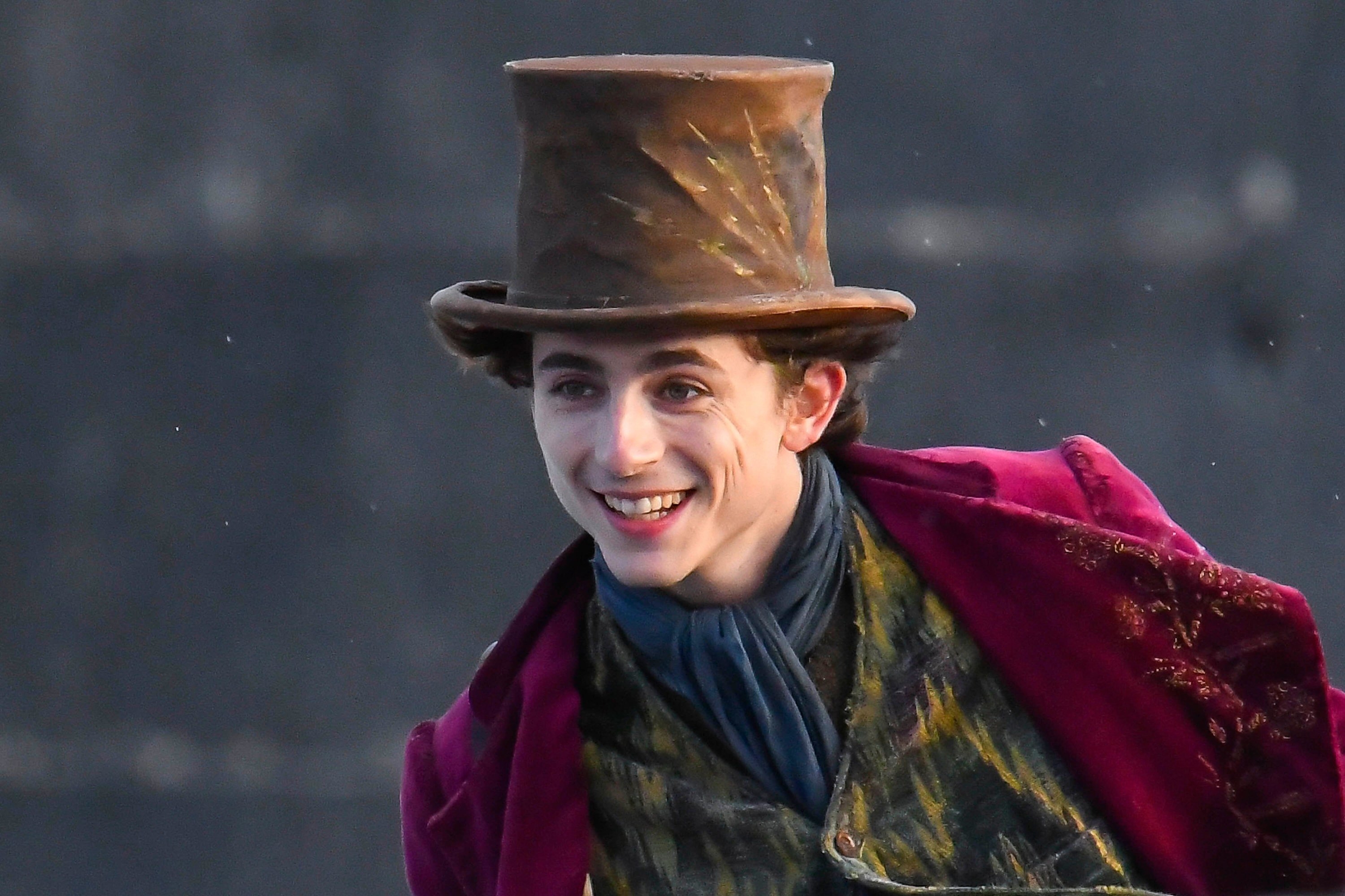 Timothee Chalamet filing scences for the new Wonka movie starring Timothee Chalamet being filmed on The Cobb harbour at Lyme Regis in Dorset