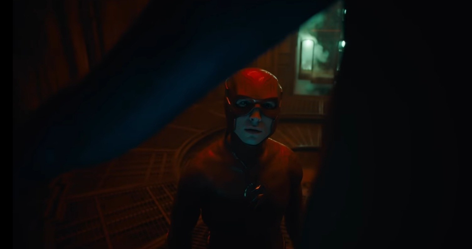 The Flash examines a costume in a futuristic room