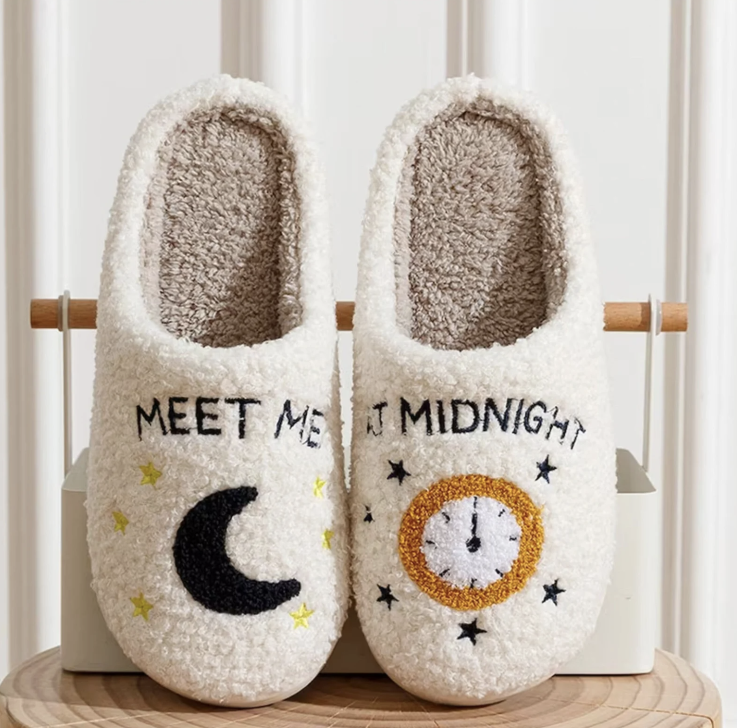 The slippers on a wooden table leaning against a bin