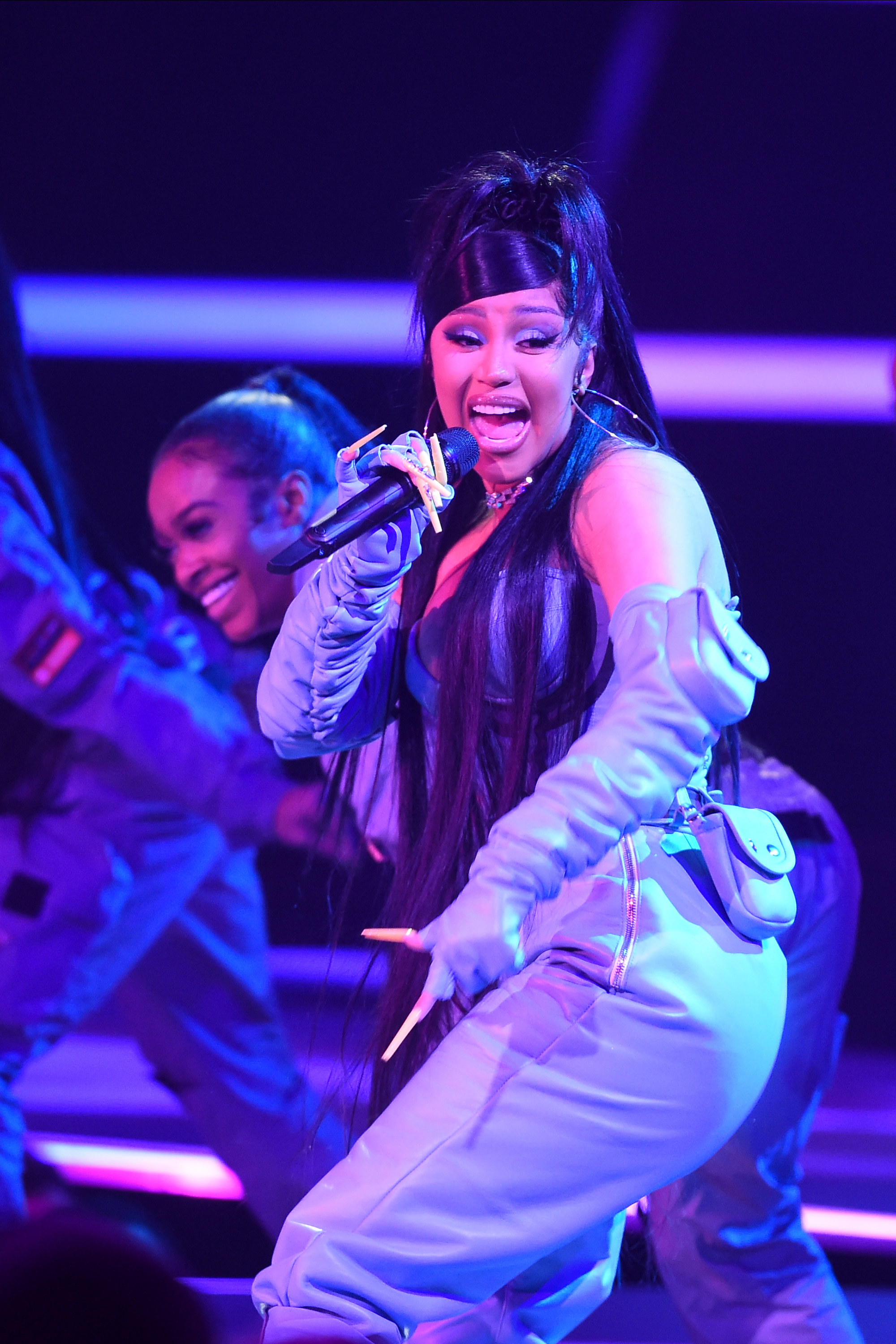 Cardi performing onstage with backup dancers
