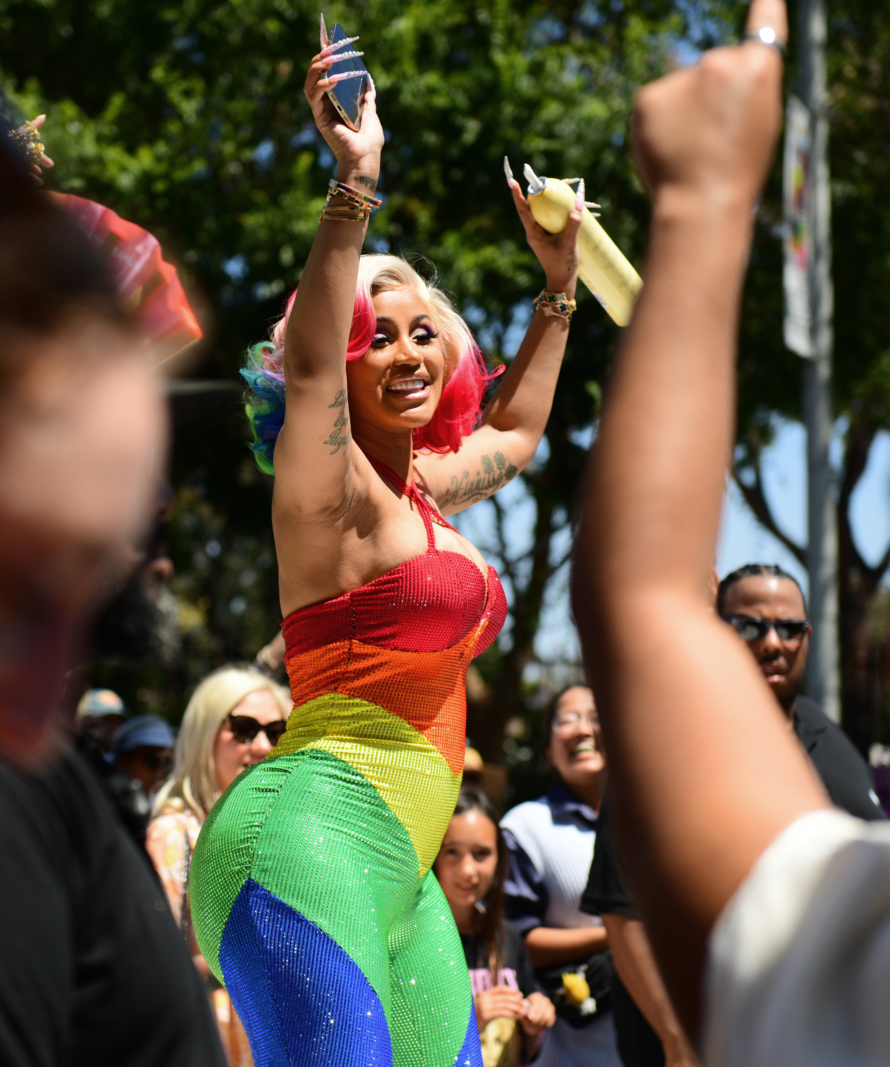 Cardi B in a rainbow-colored bodysuit and matching curled wig