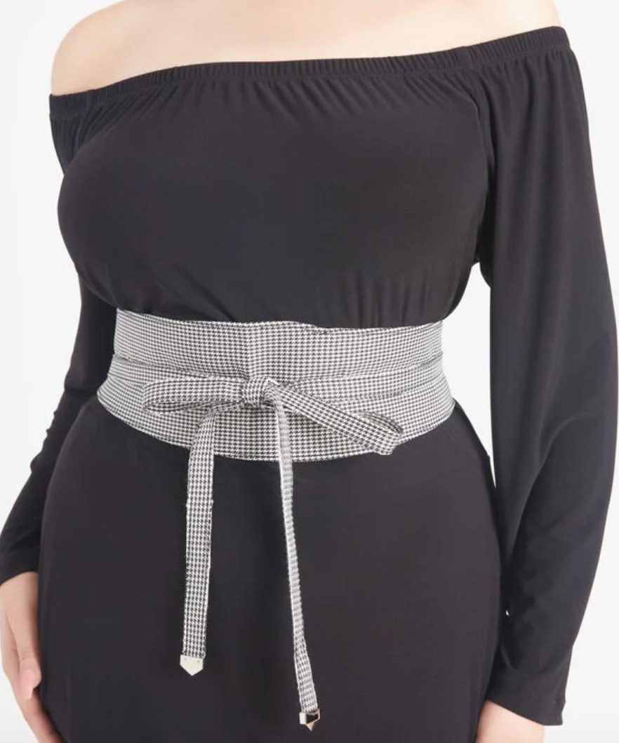 close up of a model wearing the belt with a black dress