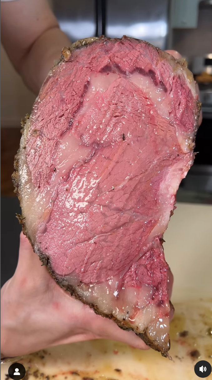 A cross-section of the juicy roast being held up