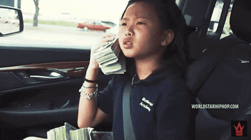 kid pretending a stack of bills is a phone