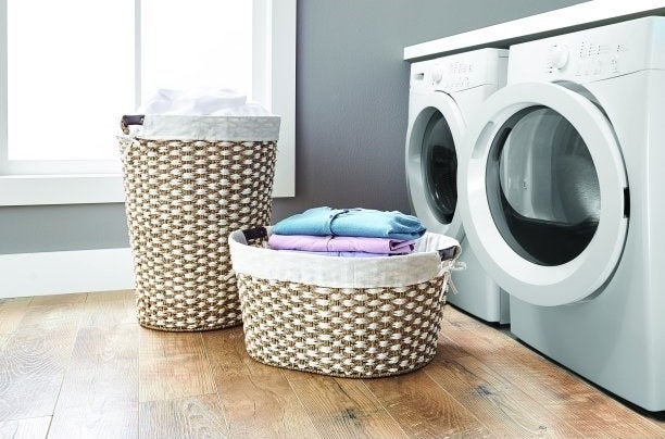 two wicker laundry hampers holding clean, folded clothes