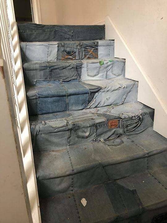 a staircase carpeted with old pairs of jeans