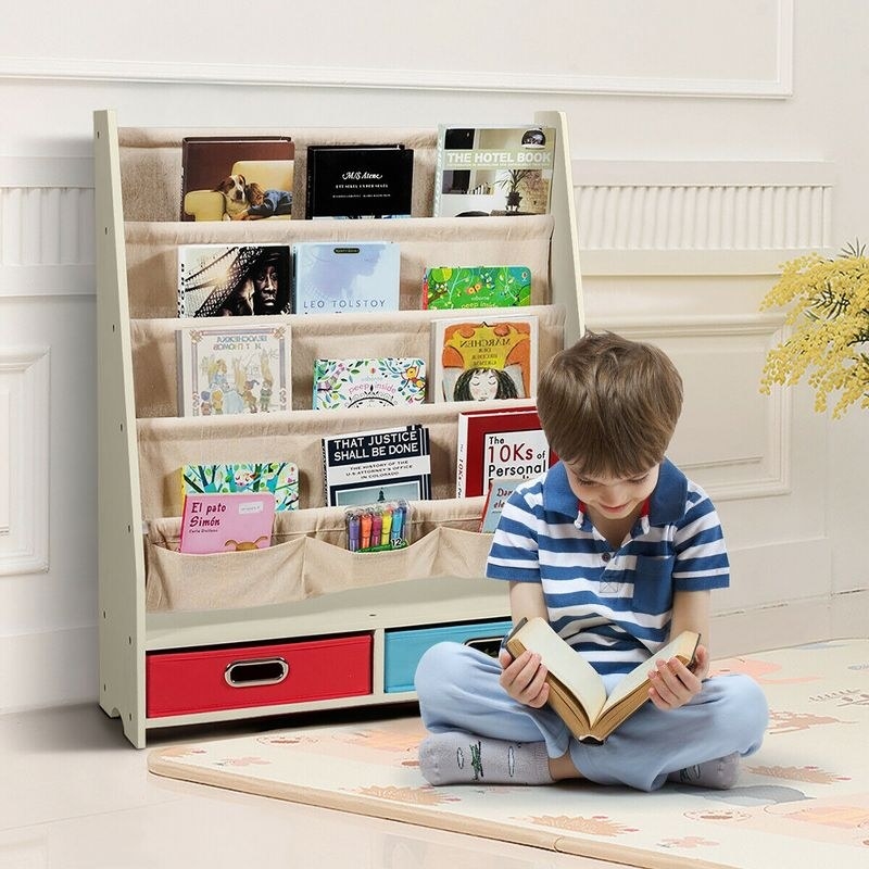Boy reading in front of book shelf