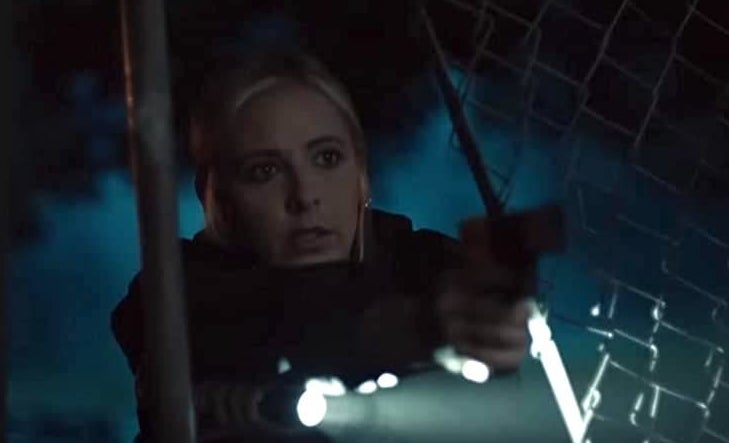 closeup of a woman pointing a gun