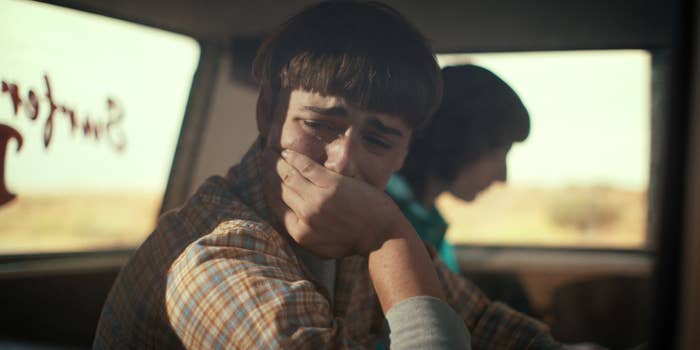 Will sitting in the passenger seat of a car and facing the window with his hand over his mouth as he cries