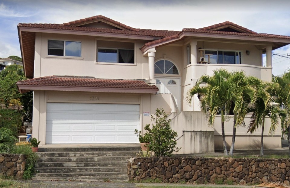 a house with some steep little stairs blocking access to the garage