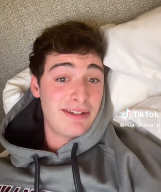 A closeup of Noah in bed in his TikTok video