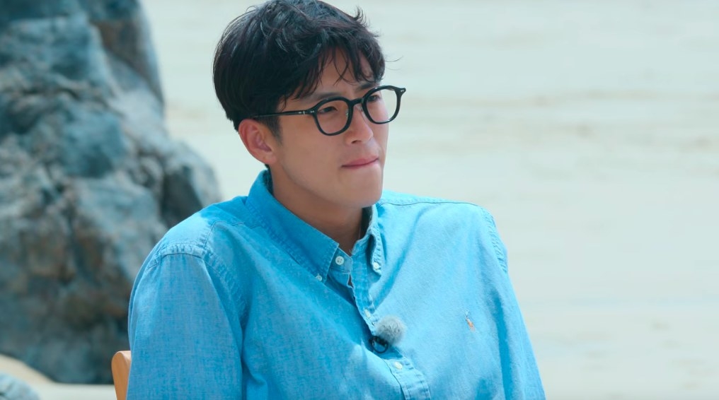 Jo-Yoong Jae bites his lip, in a blue shirt