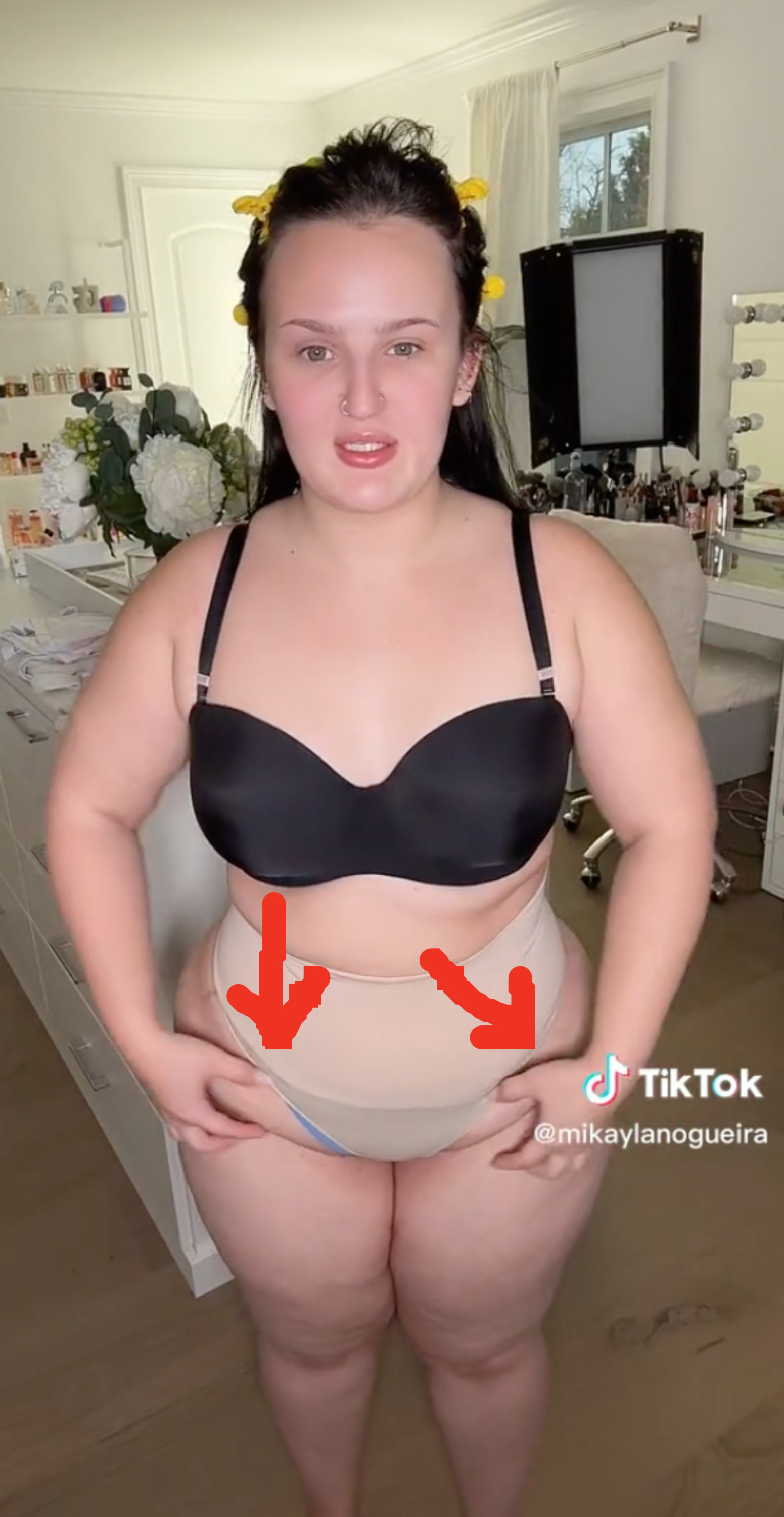 Mikayla holding onto the lower part of her stomach that&#x27;s become shaped