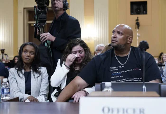 Sandra Garza (left) wipes tears from her eyes in court as US Capitol Police Sgt. Harry Dunn consoles her (right)