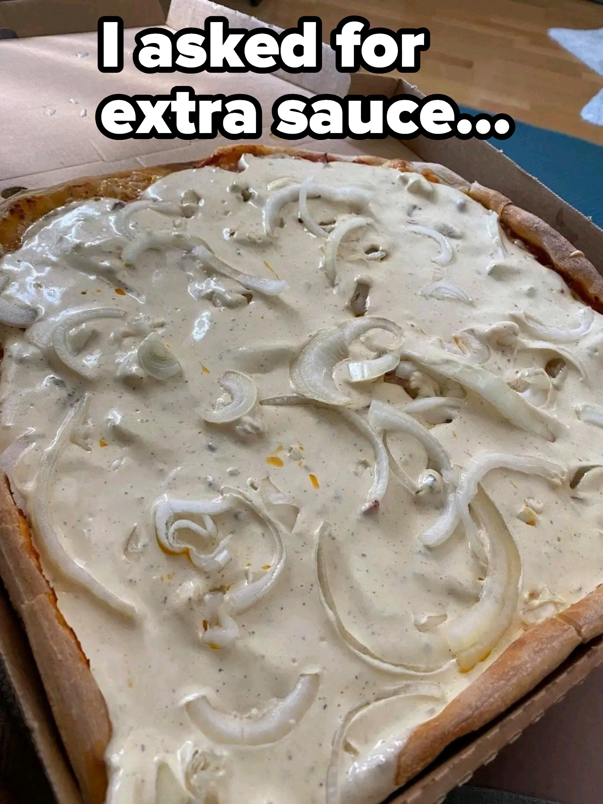 Person has a square pizza smothered with white sauce