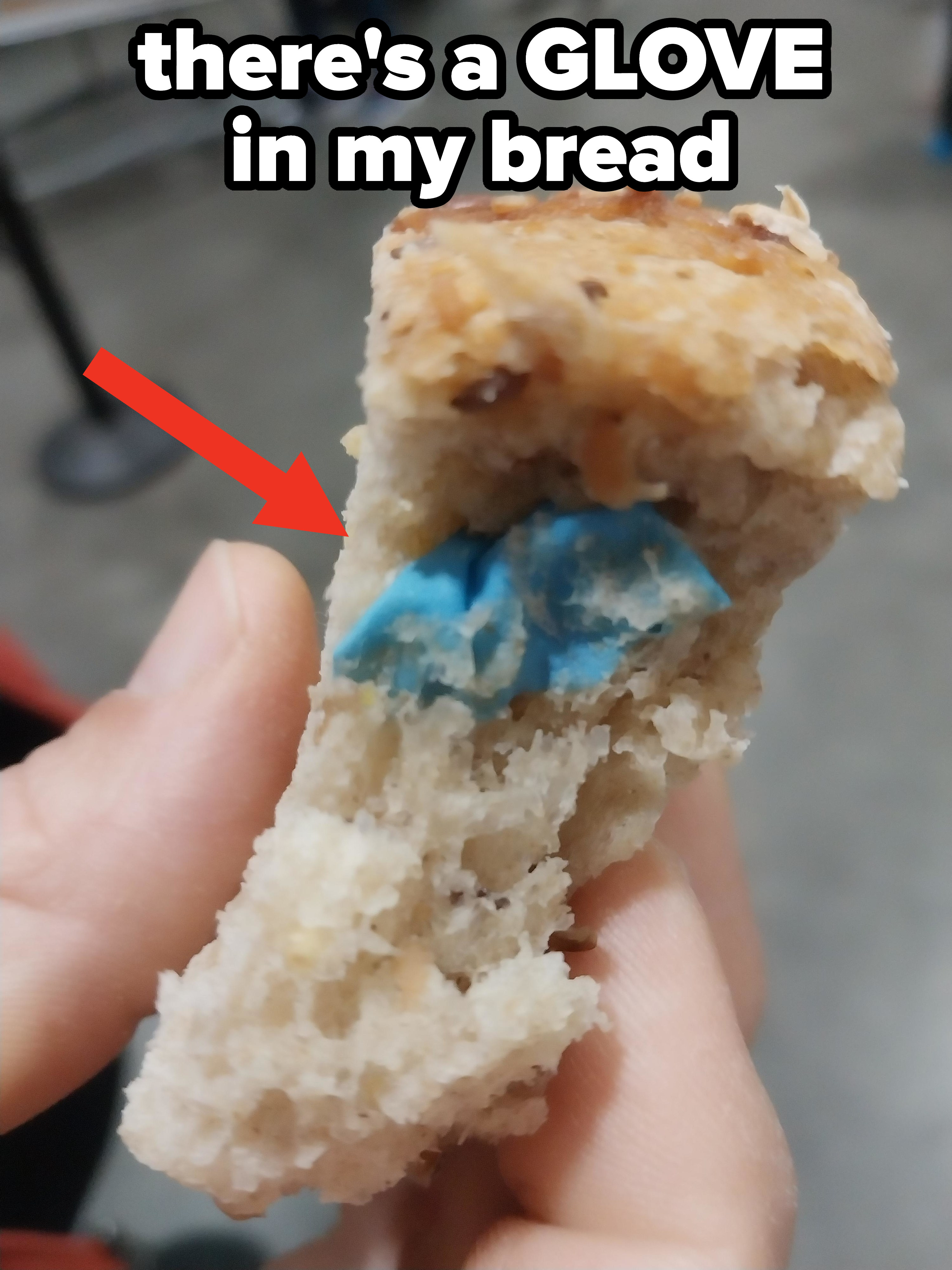 A blue medical glove inside a piece of bread