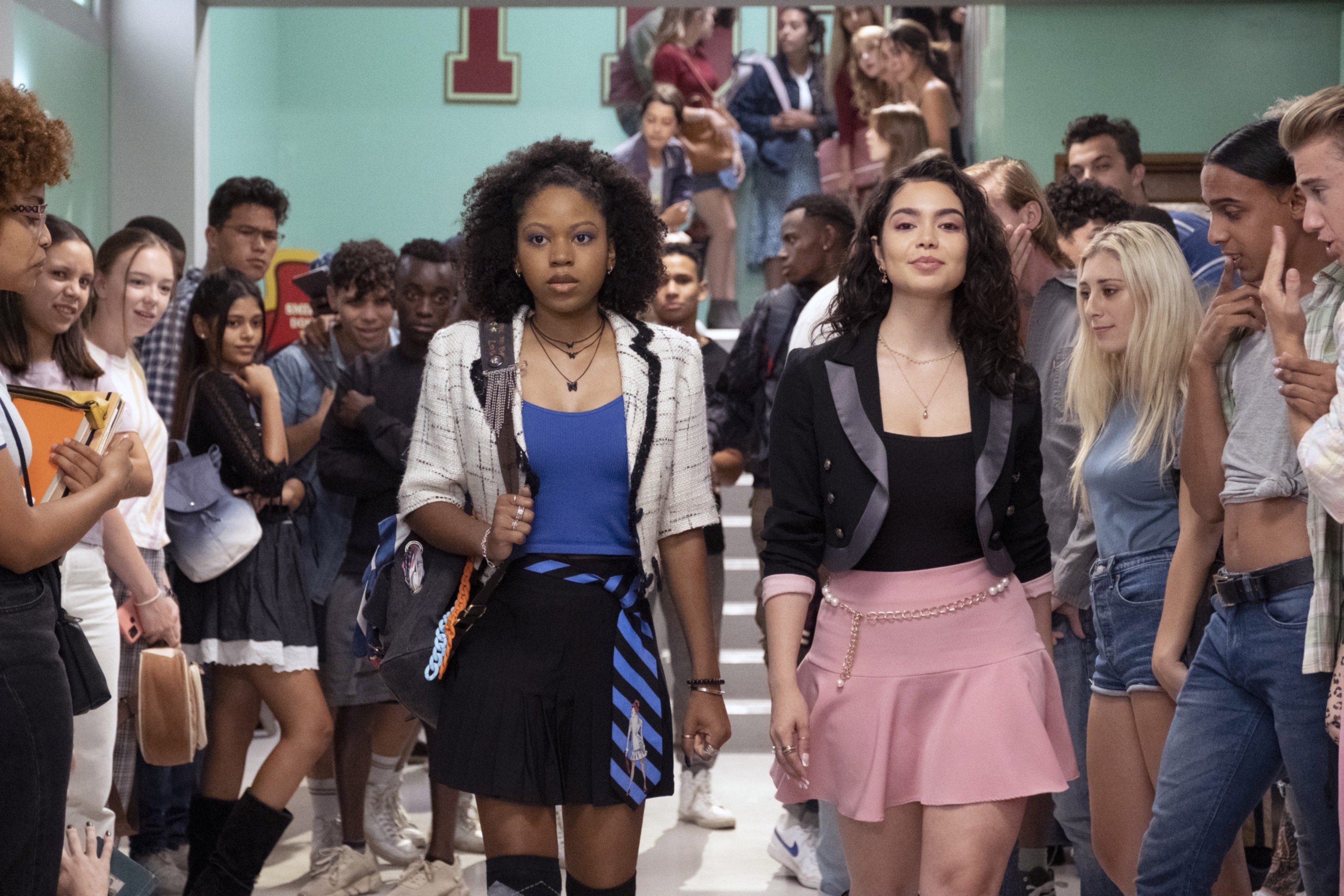 Two girls walk down their high school hallway