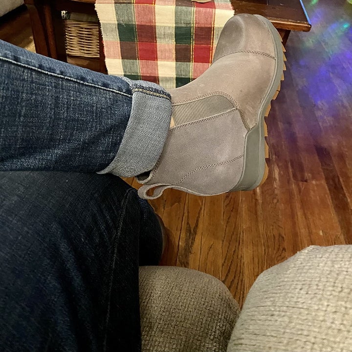 A reviewer wearing a grey shoe