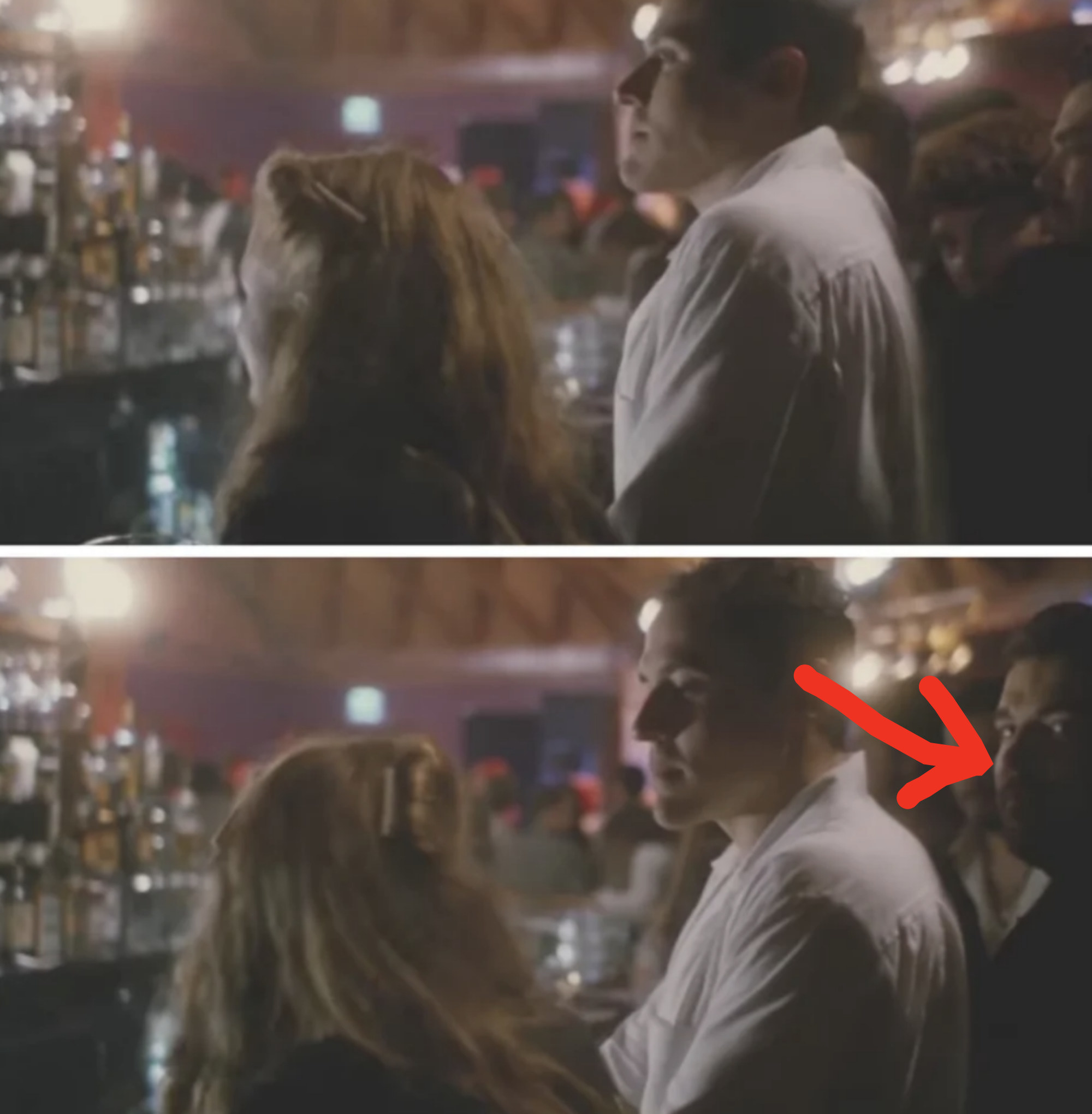 arrow pointing to the extra looking at the camera while standing behind the actor
