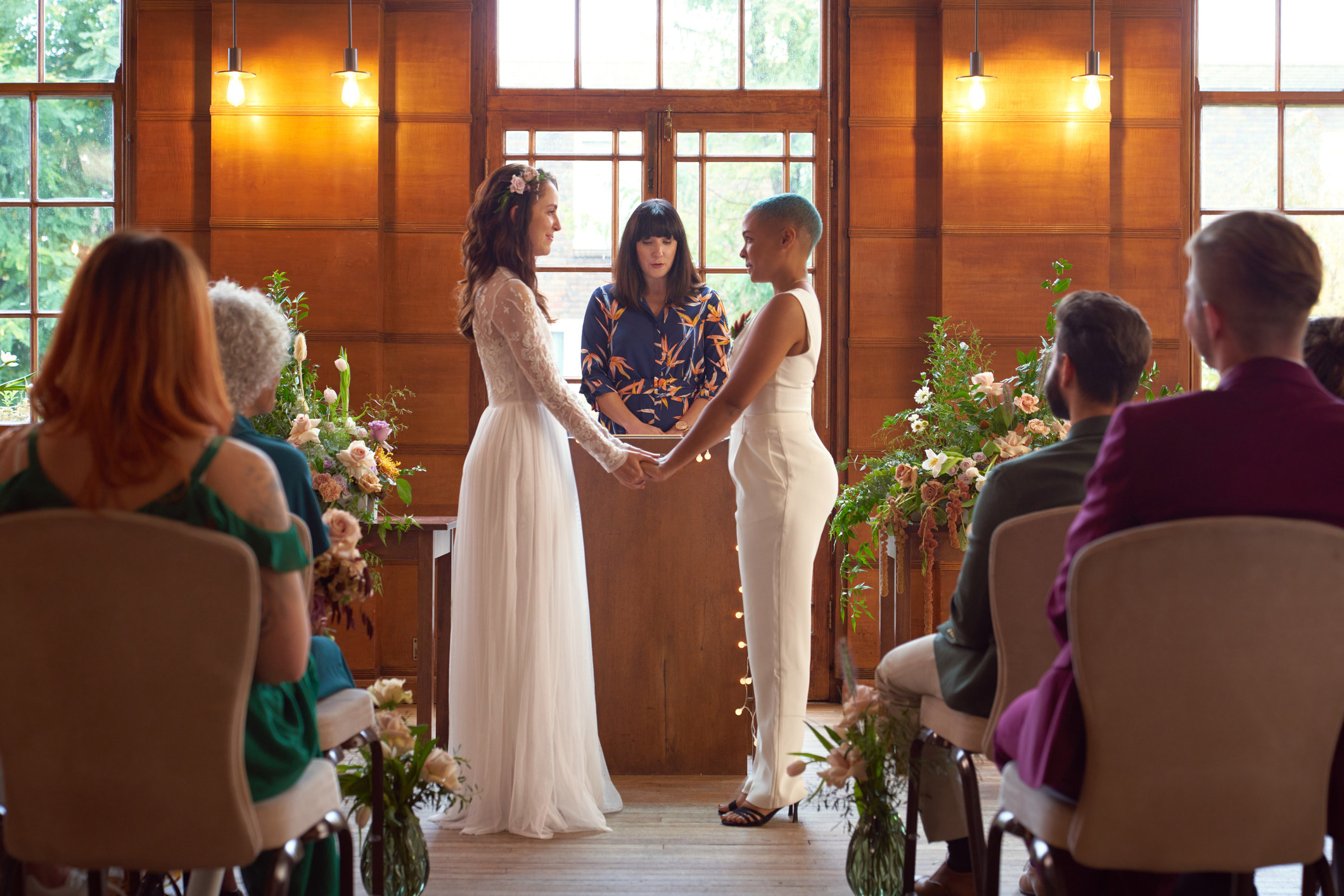 two woman at the alter exchanging vows