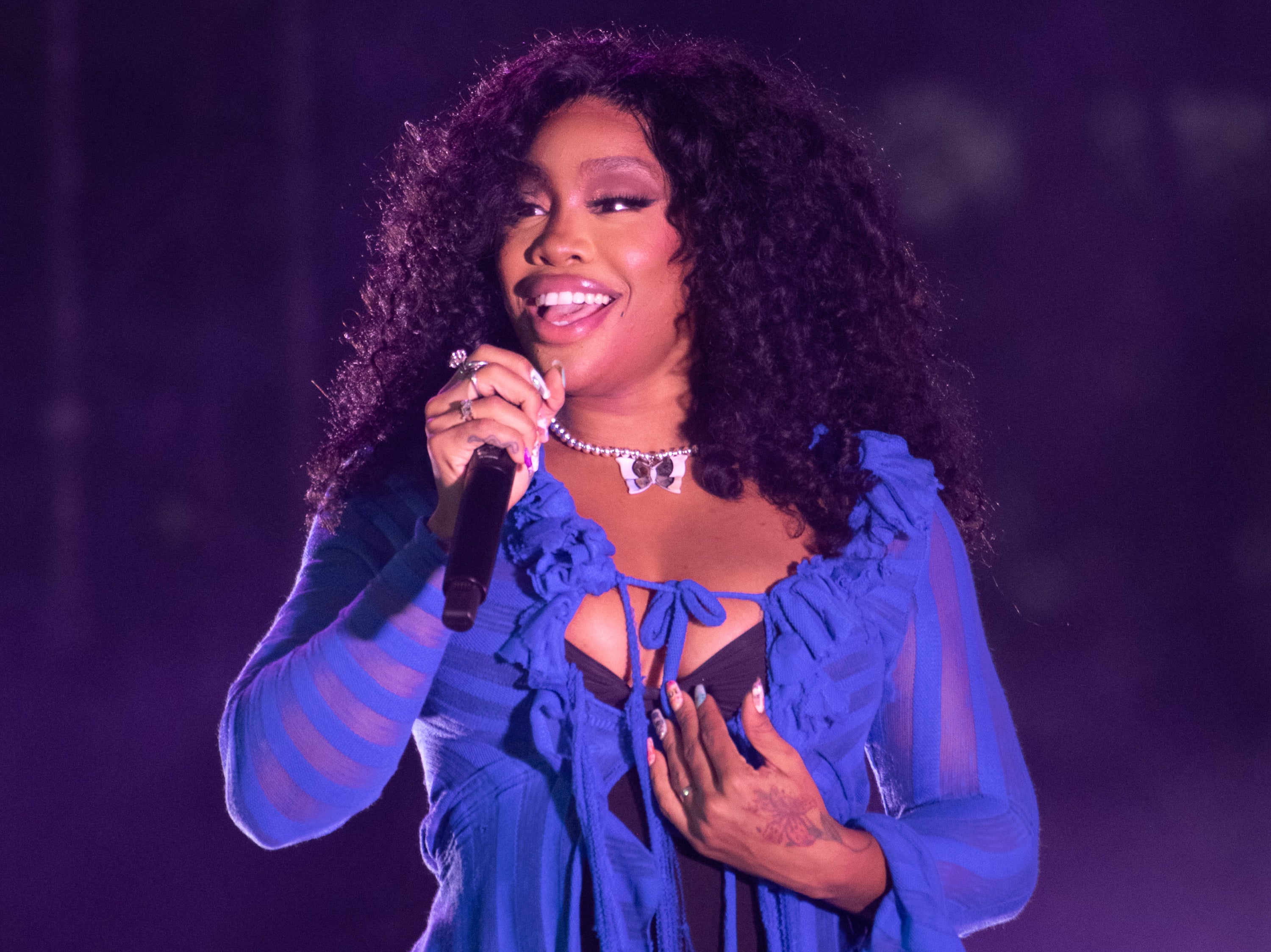 A close-up of SZA performing