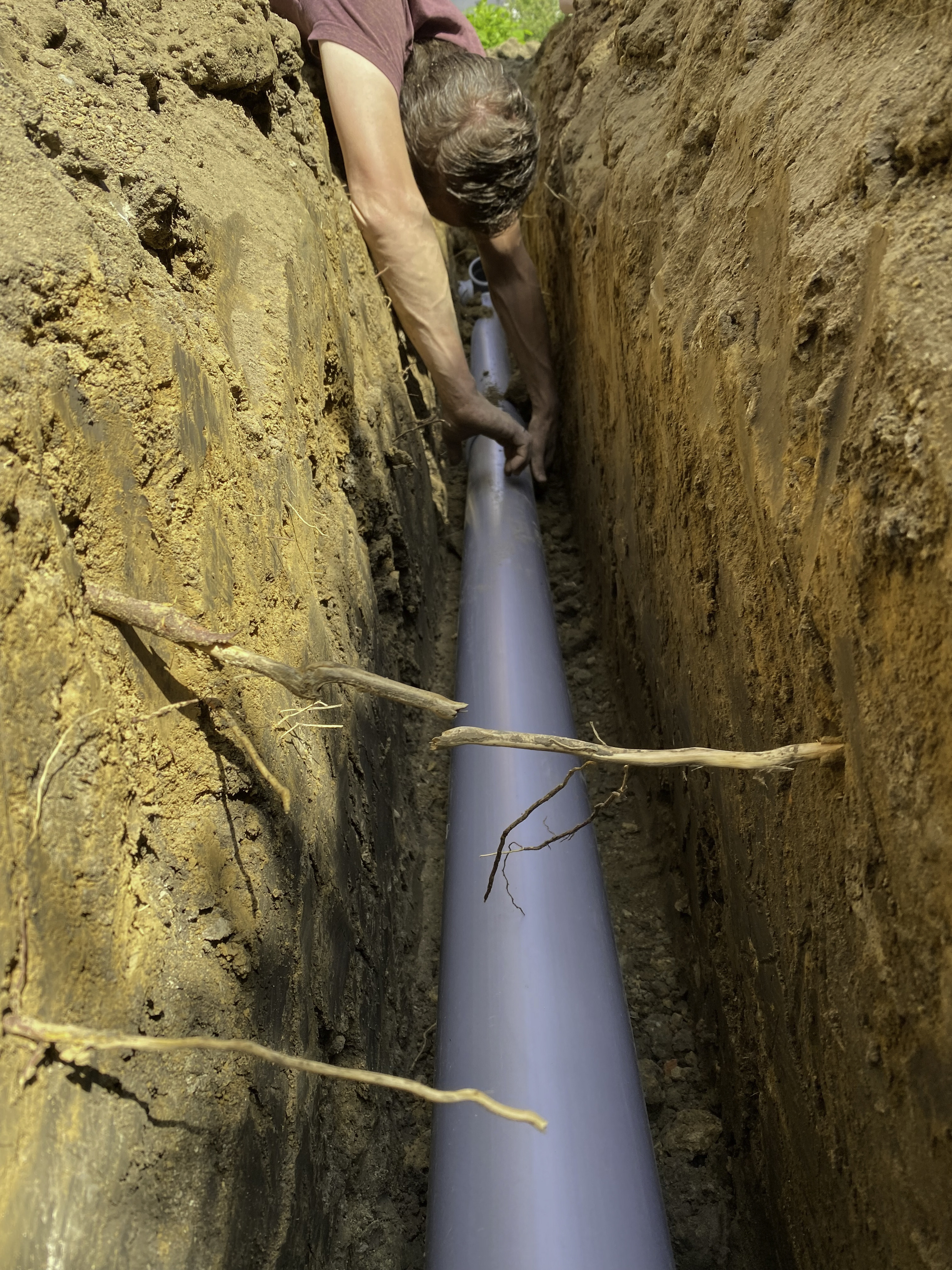 sewer line being installed in trench outside home