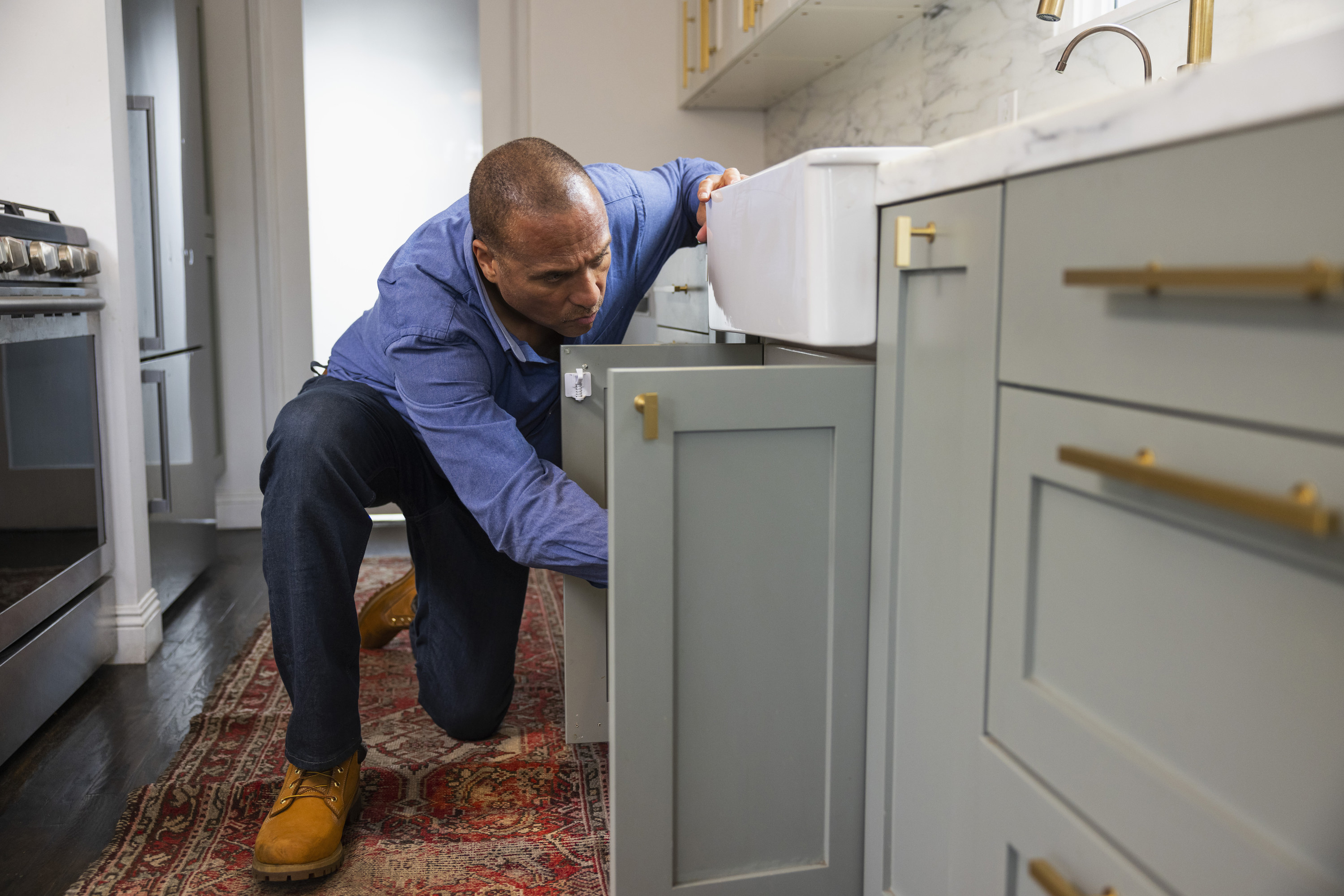 plumber reaching under sink