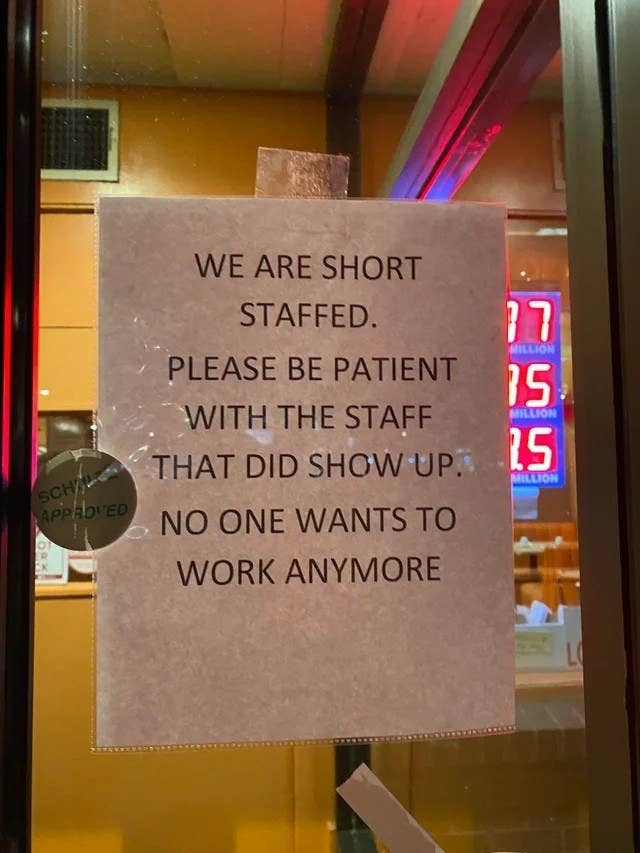 sign in a restaurant window saying they are short staffed because nobody wants to work anymore