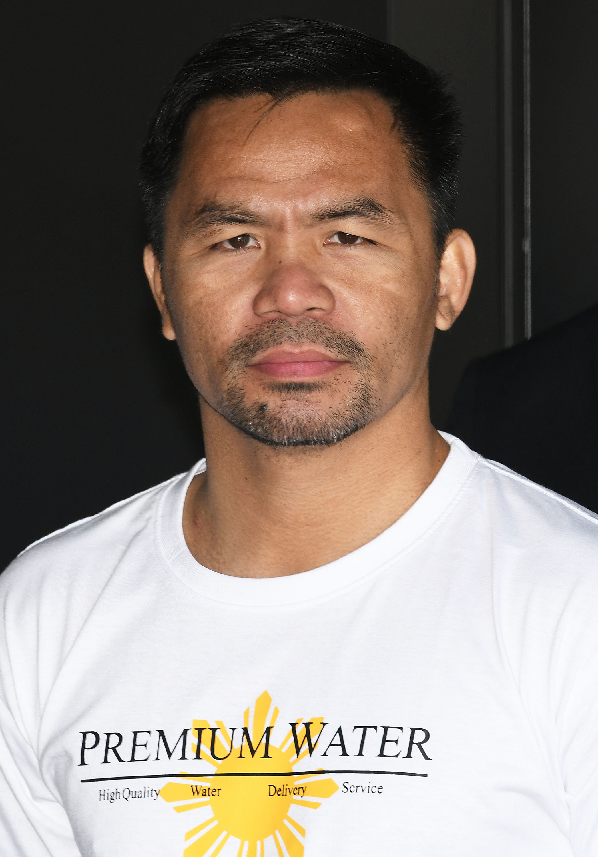 A close-up of Manny wearing a t-shirt that says &quot;Premium Water&quot;