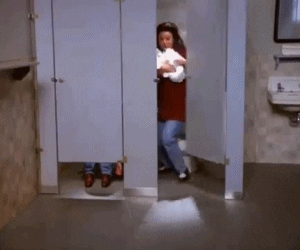 Elaine running out of a bathroom stall with a bunch of toilet paper