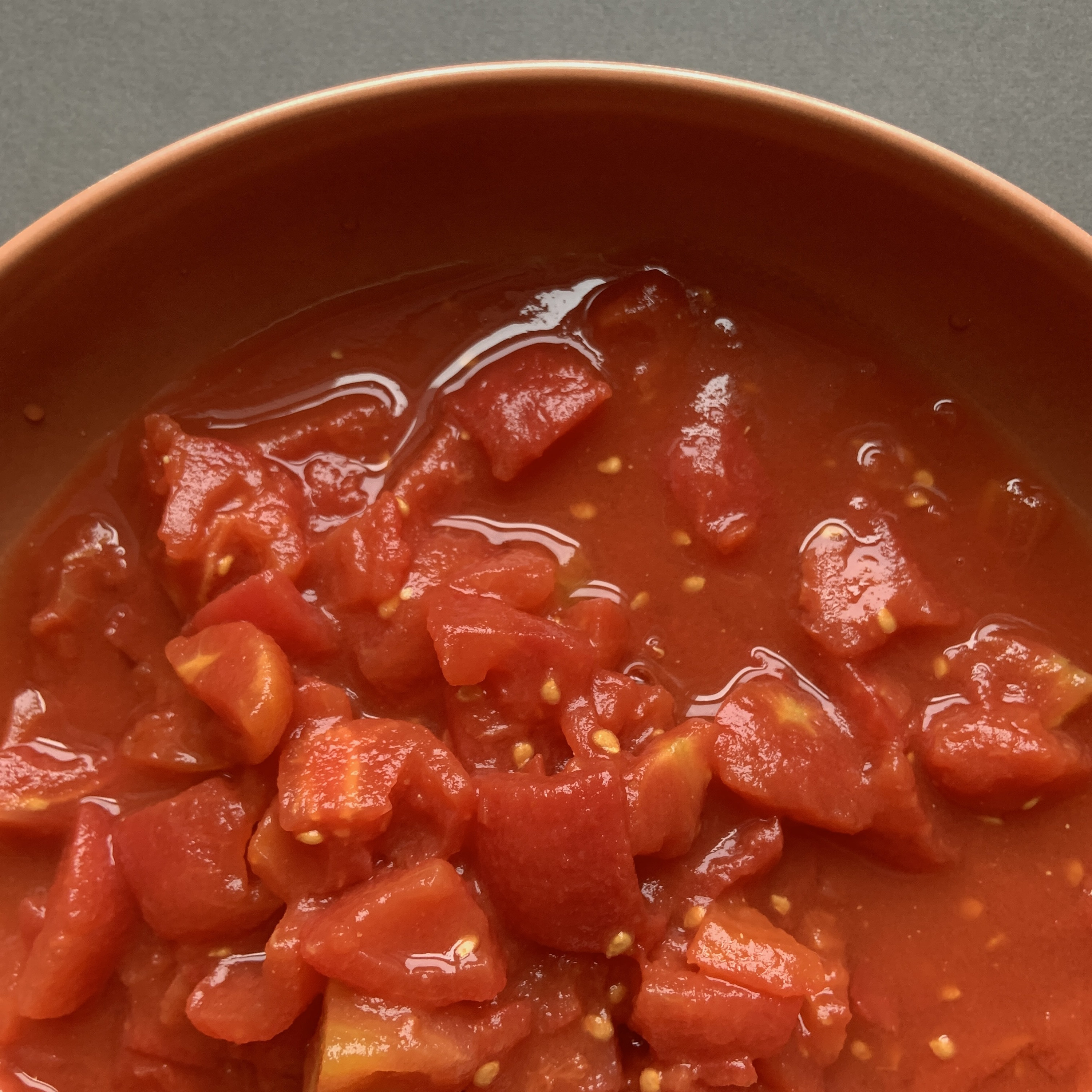 canned tomatoes in a bowl with juices