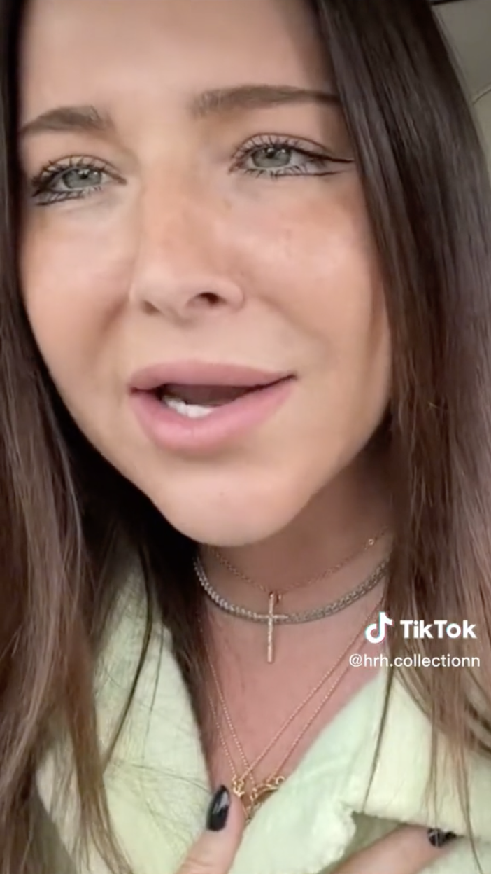 A screenshot of TikTok showing a brown-haired white woman with her face very close to the camera