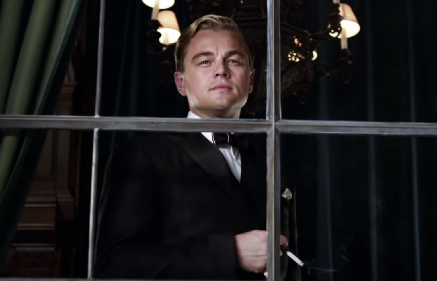Leonardo DiCaprio as Jay Gatsby looking out of a window
