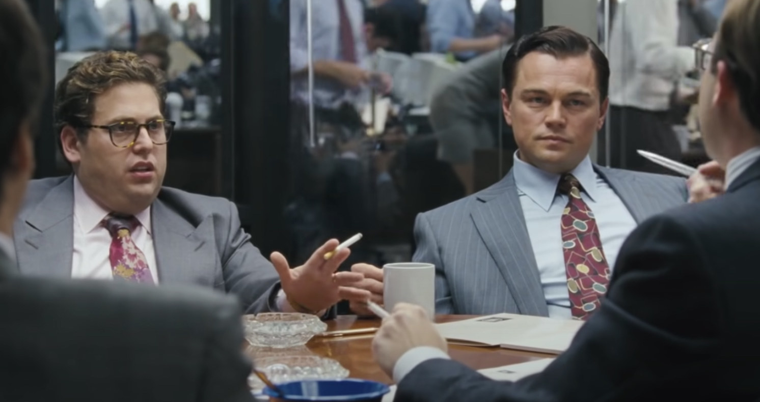 Jonah Hill and Leonardo DiCaprio talking at a meeting in The Wolf of Wall Street