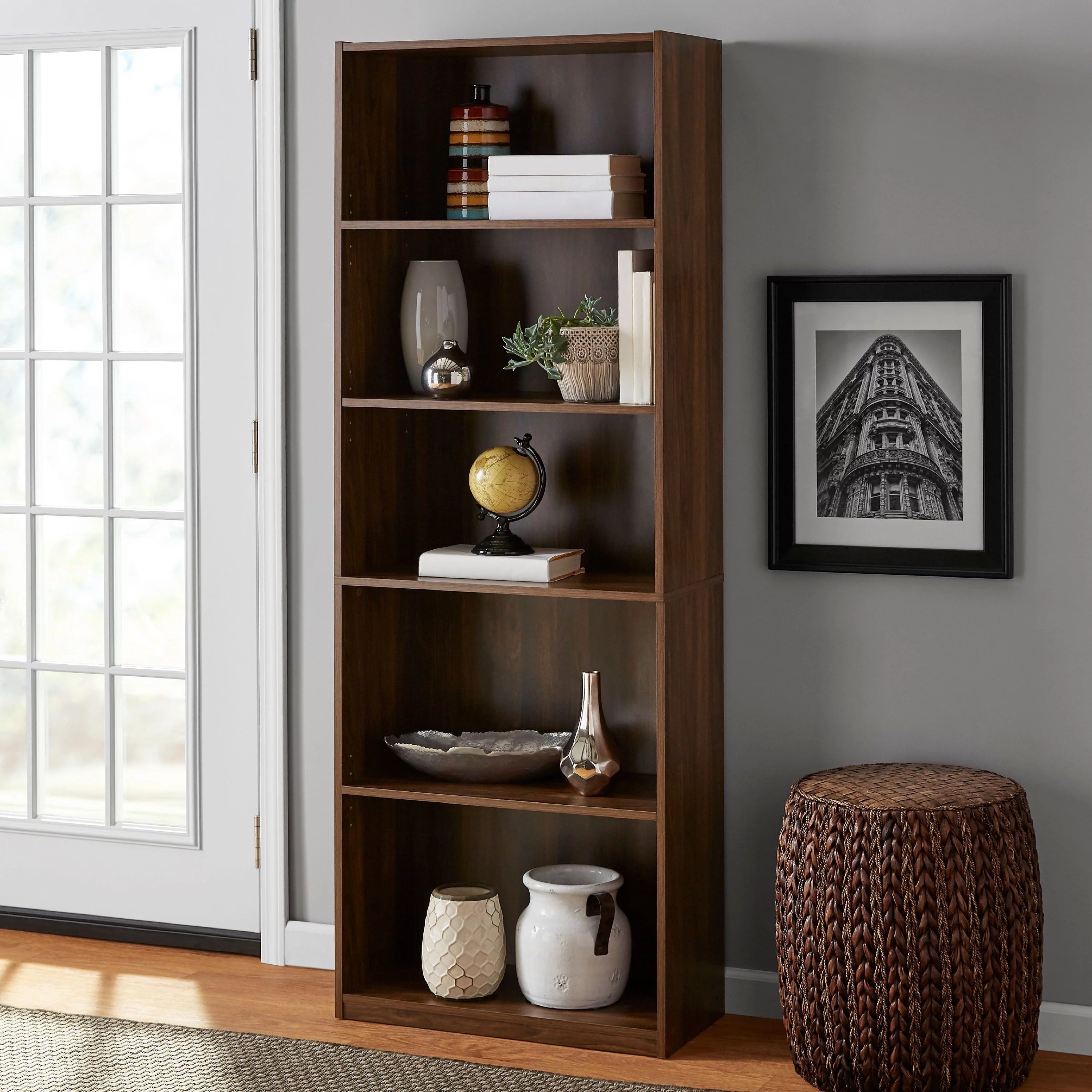 a canyon walnut colored bookcase holding books and home pieces