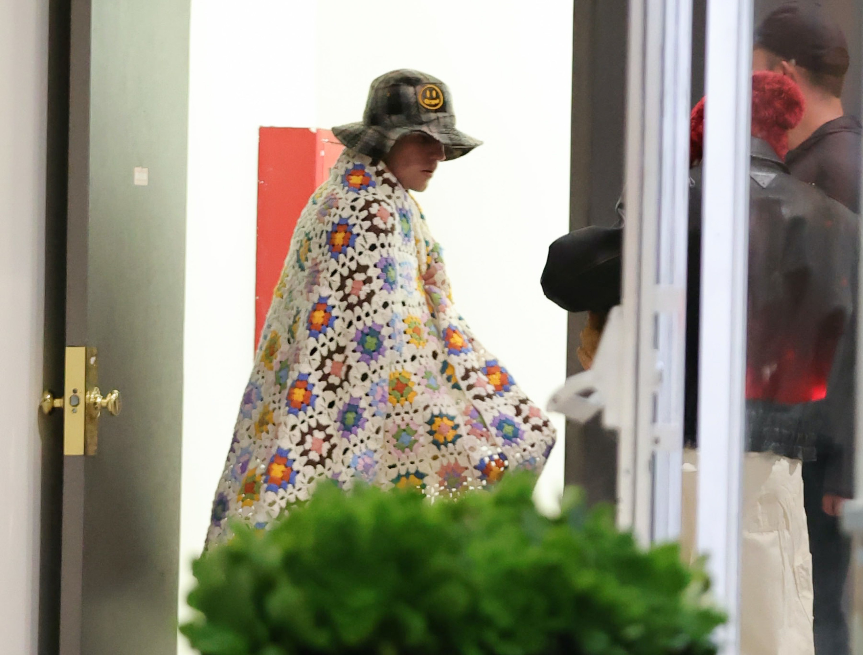Justin Bieber wearing a blanket out in public