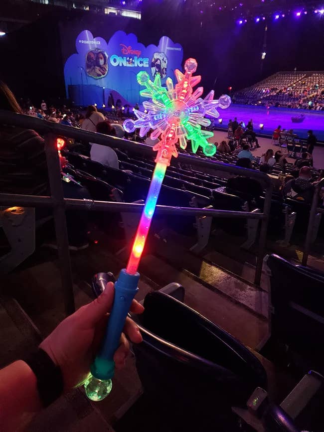 reviewer's photo of the lit up snowflake wand