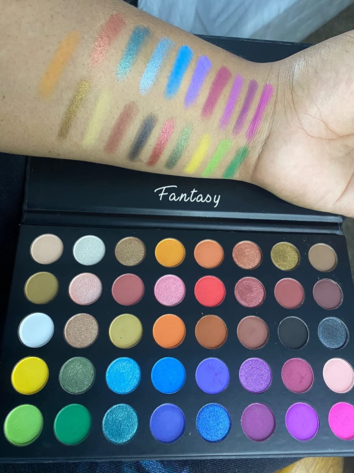 reviewer image of the full palette with swatches on their arm