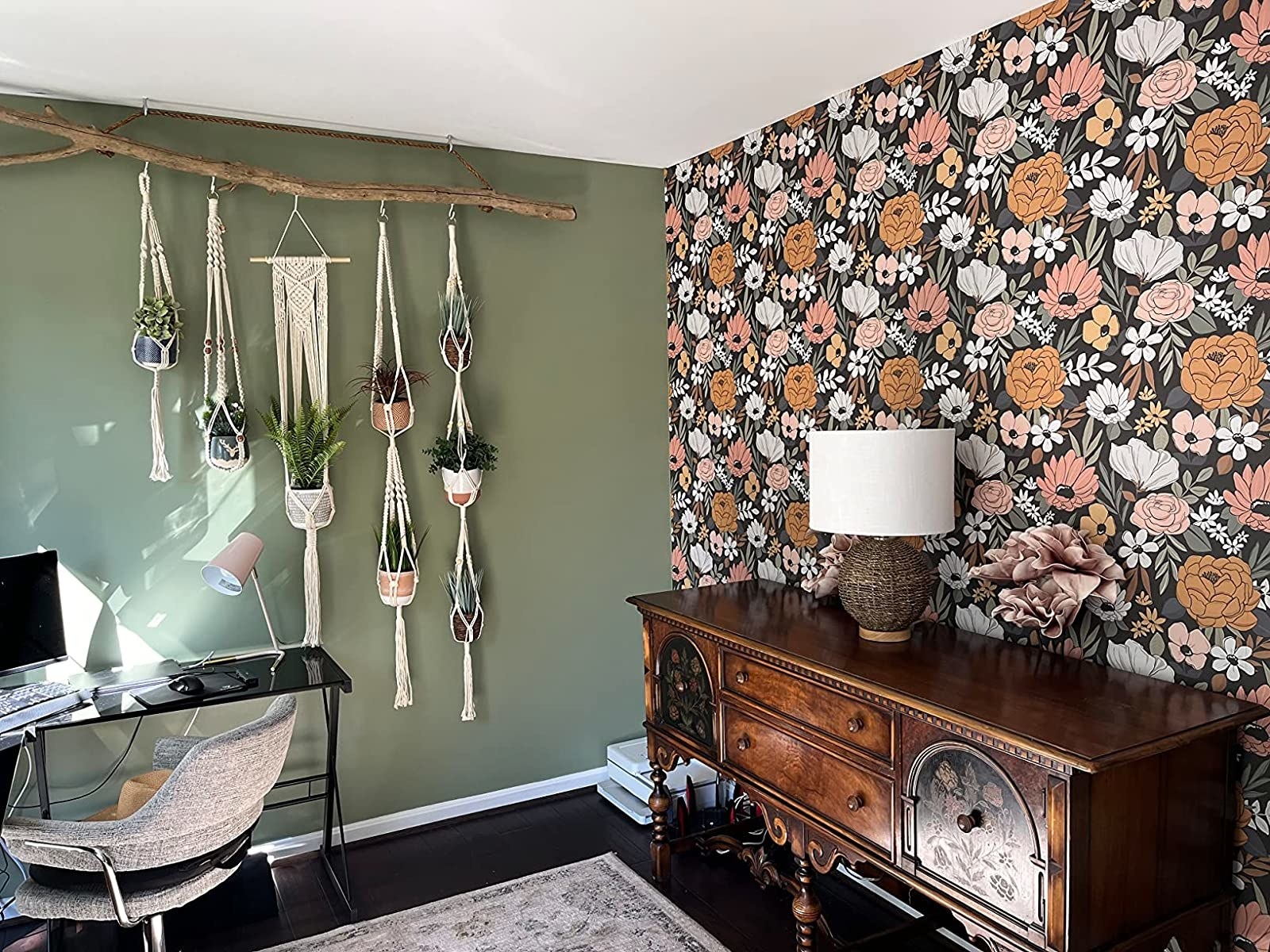 a reviewer's home office with one wall covered in the pink, white, and black floral wallpaper