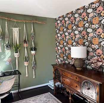 a reviewer's home office with one wall covered in the pink, white, and black floral wallpaper