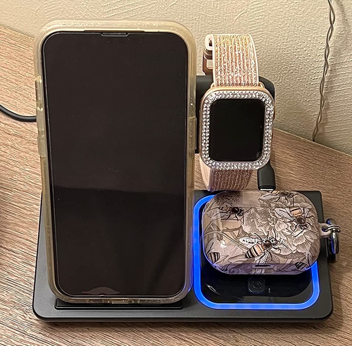 Reviewer&#x27;s charger with phone, Airpods, and watch charging up