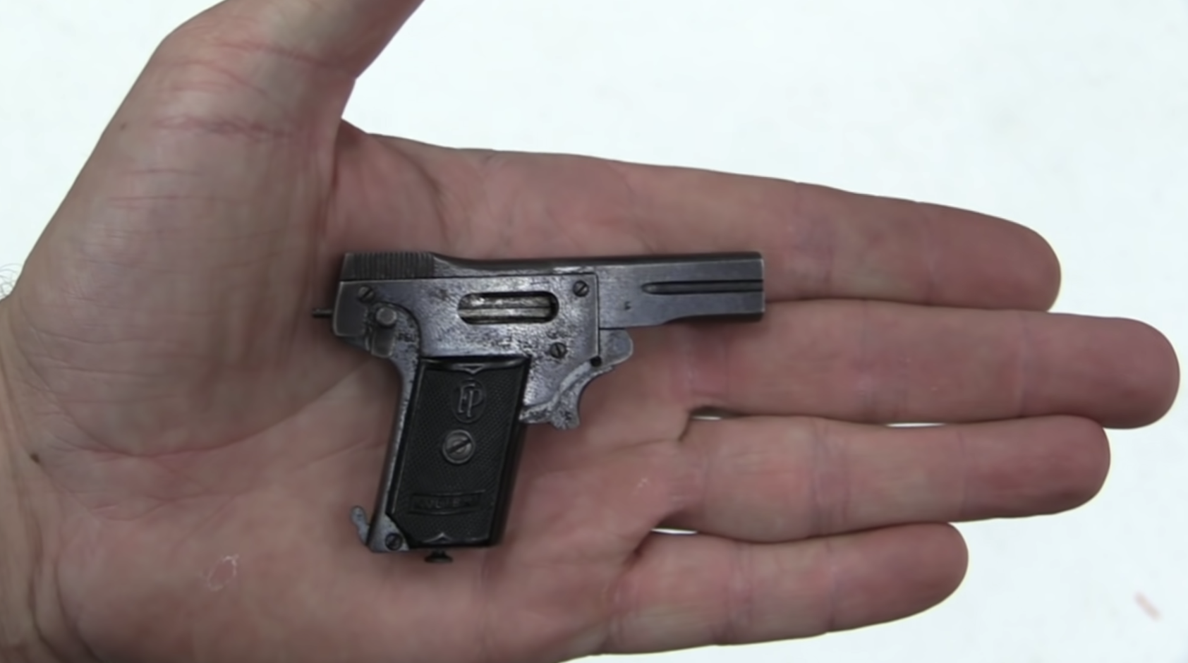 A pistol fitting in the palm of a hand