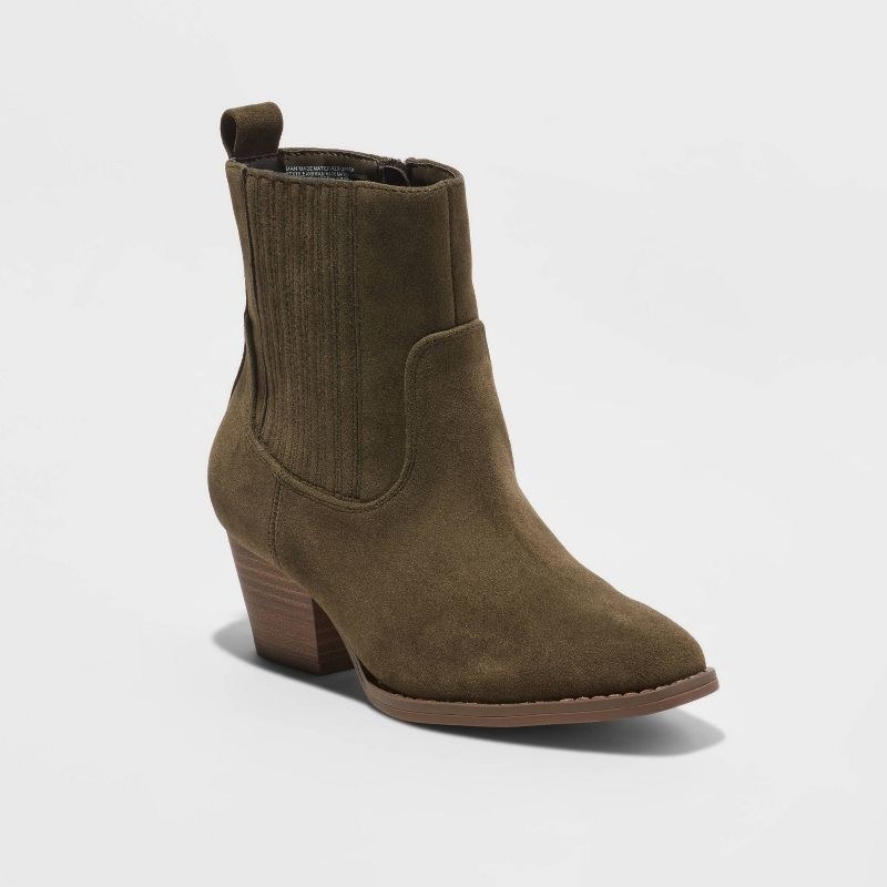 A green pair of boots with brown heel