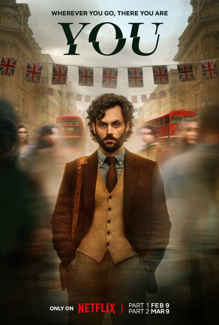 Joe stands as people and London double-decker buses go by him in a promo photo for the show