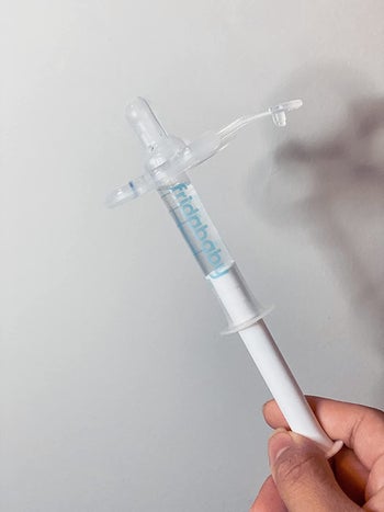 Reviewer holding the medicine dispenser