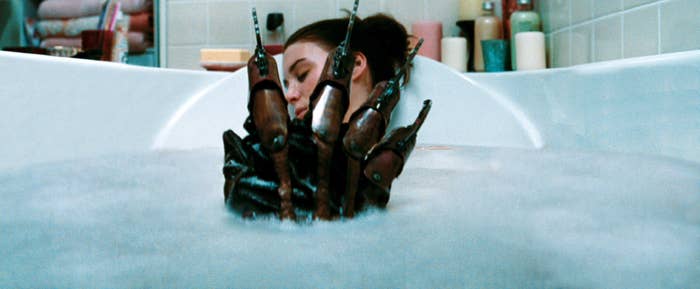 Rooney in a bathtub as Freddy Krueger&#x27;s hand emerges from the water
