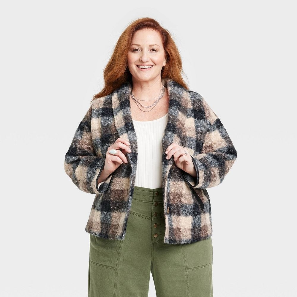 Model in black, brown and cream blazer-like sweater jacket