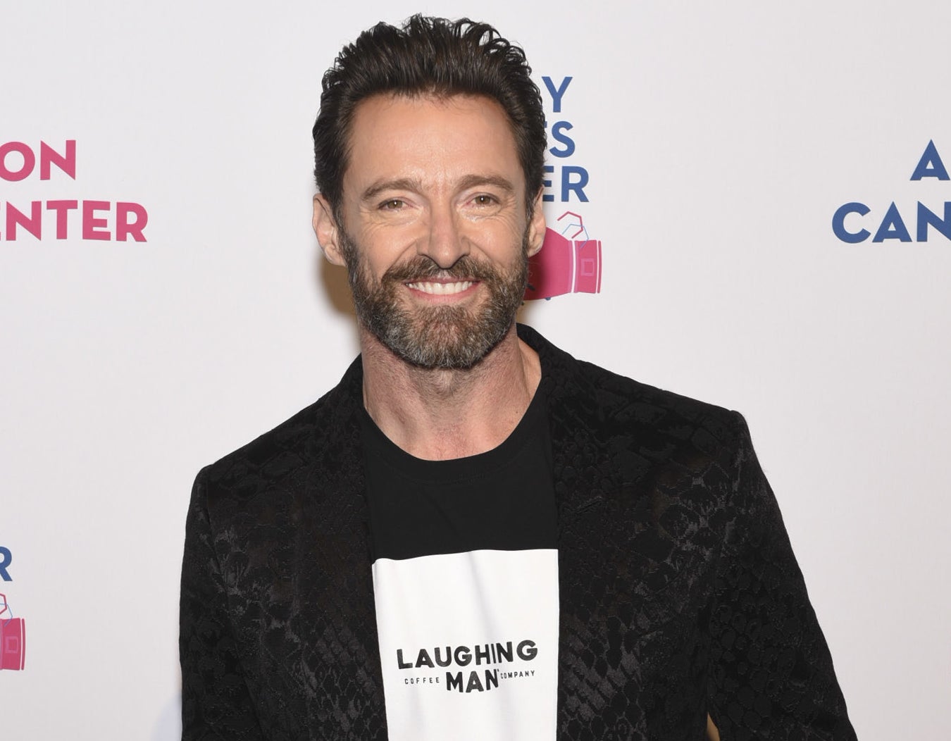 Hugh smiling in a &quot;Laughing Man&quot; top