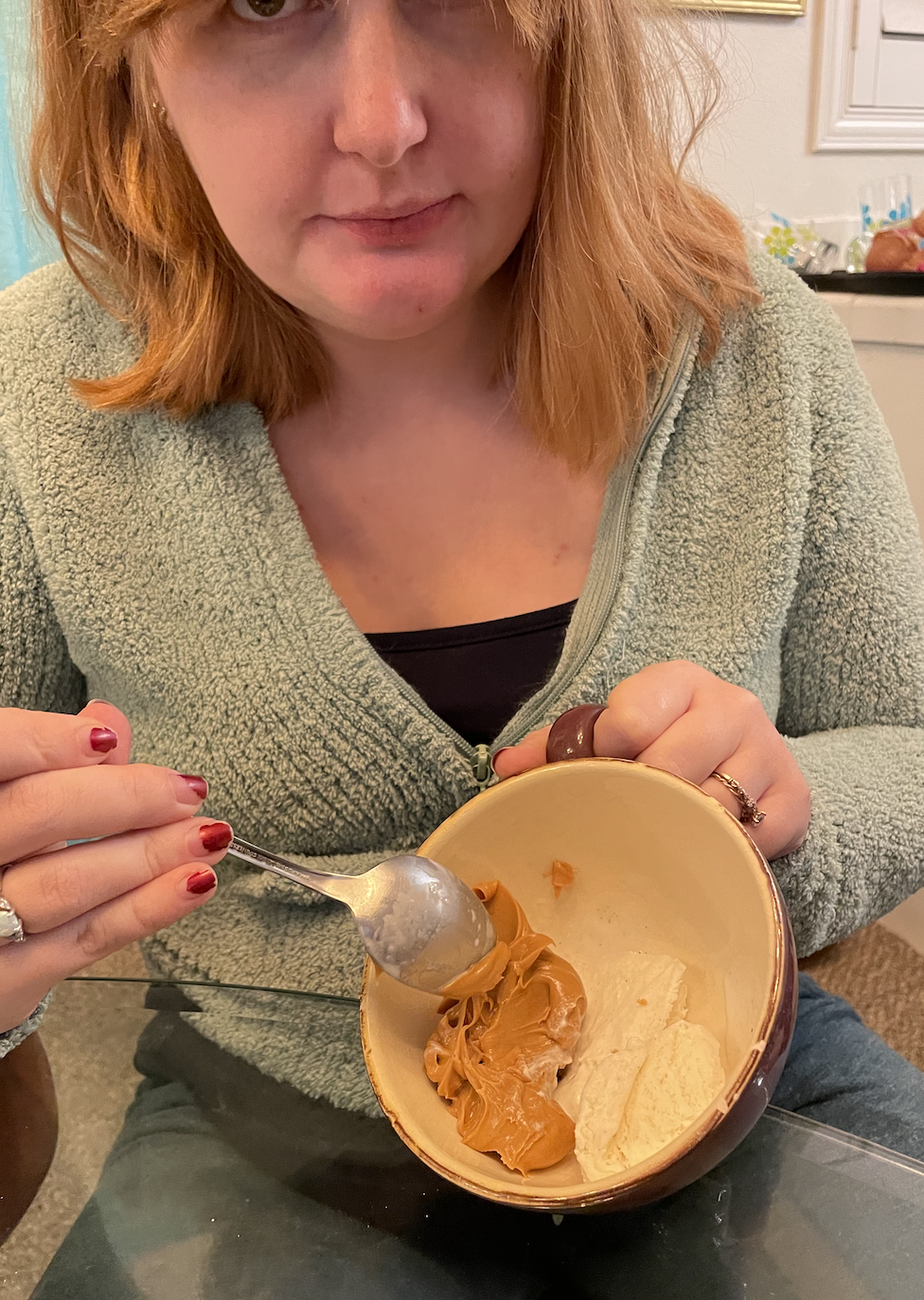 author showing a bowl of ice cream and peanut butter